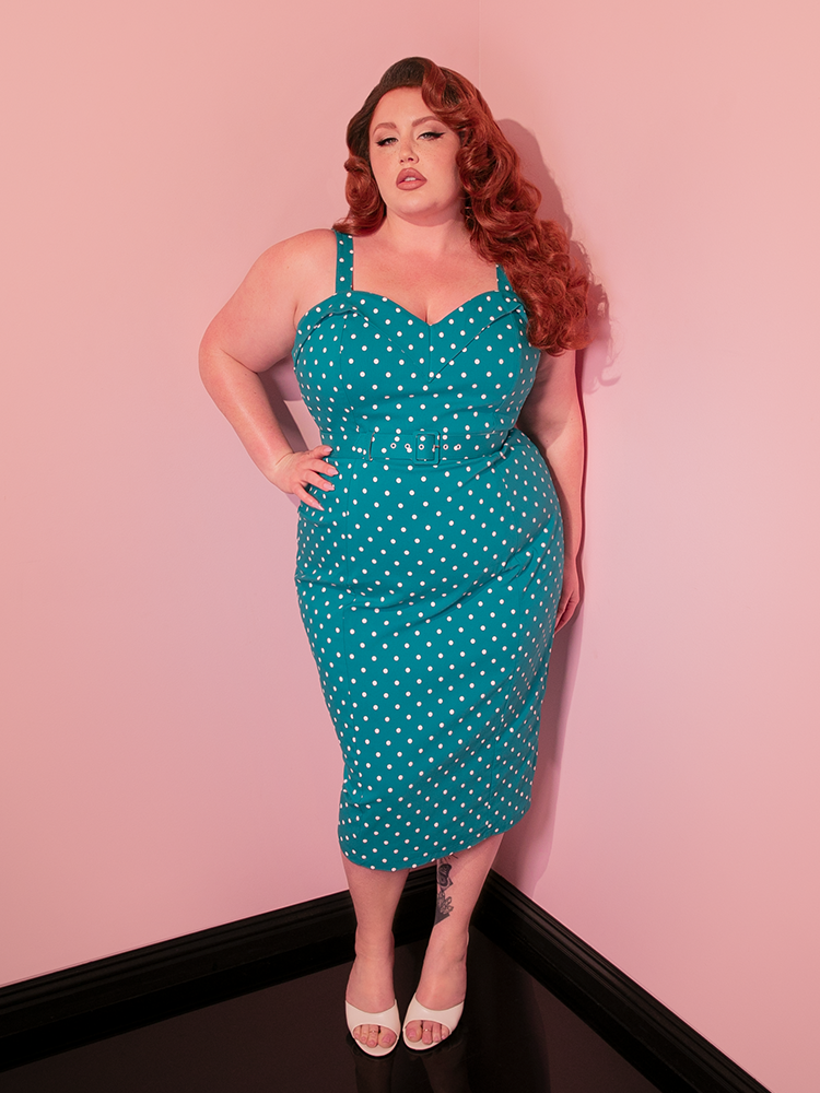 This retro-inspired gown, the Maneater Wiggle Dress in Teal Blue Polka Dot, channels the sophistication of vintage dresses with a modern twist.