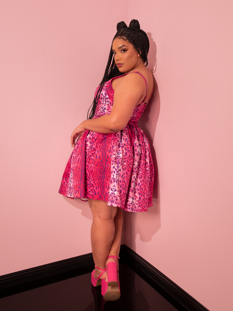 Posing with confidence, the stunning female model rocks the Vixen Skater Skirt in Pink Leopard Print from the gothic clothing brand La Femme en Noir.
