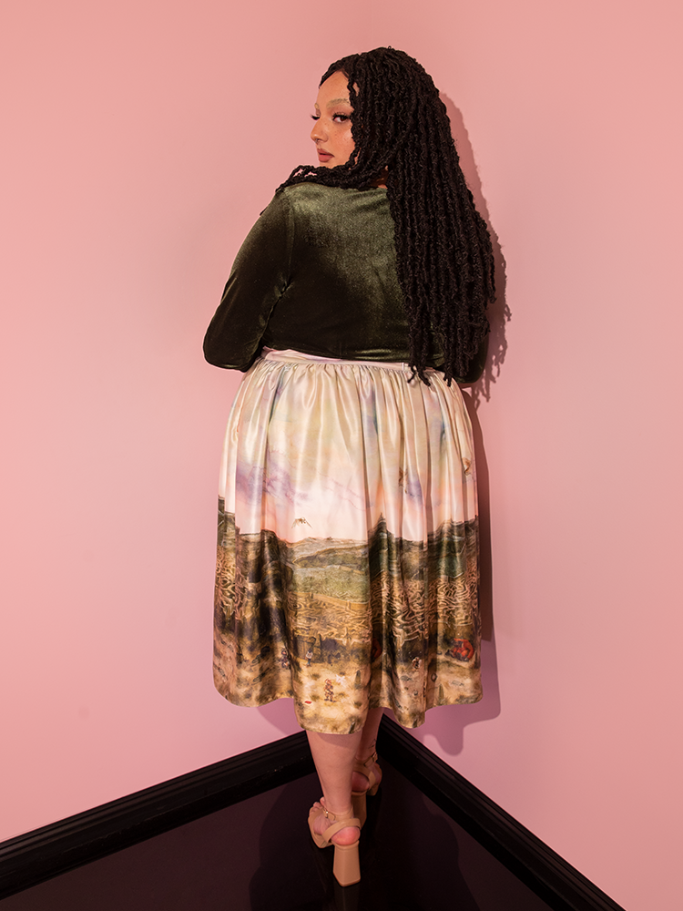 An enchanting model epitomizes the retro allure of Vixen Clothing's LABYRINTH™ Renaissance Skirt in the Labyrinth Watercolor Print.