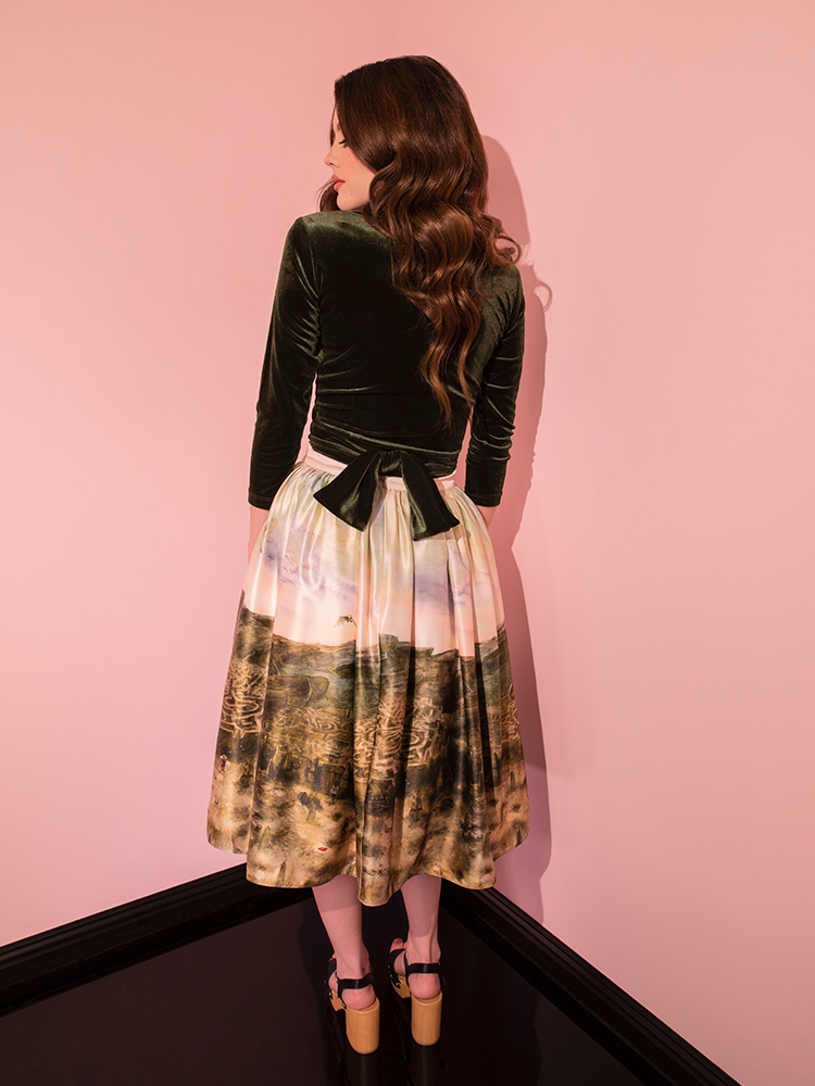 A beautiful model showcases the LABYRINTH™ Renaissance Skirt featuring the Labyrinth Watercolor Print from Vixen Clothing, embracing the essence of retro fashion.