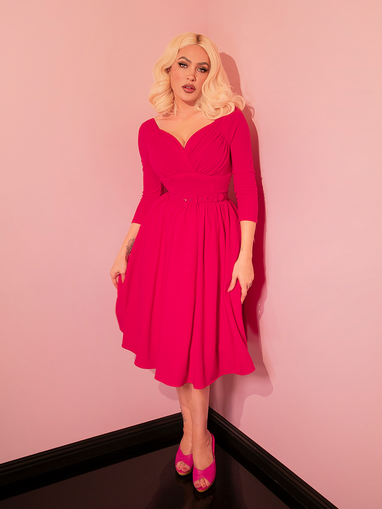 For those who adore the elegance of vintage clothing, the Starlet Swing Dress in Fuchsia by Vixen Clothing is a dream come true. Its classic swing design and eye-catching color make it a standout piece in any retro-inspired wardrobe.