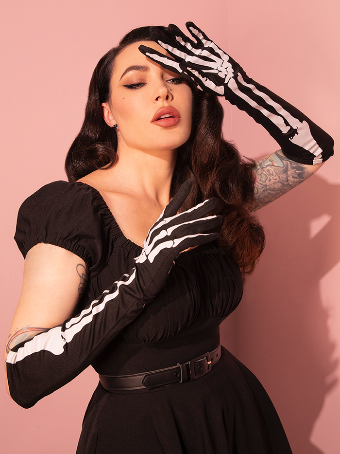 Micheline Pitt graces us with her presence, showcasing Vixen Clothing's Skeleton Print Full-length Opera Gloves, adding a touch of vintage drama to her ensemble.