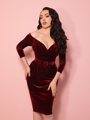 A vintage style dress in luxurious teal velvet, designed with a refined wiggle silhouette that channels iconic classic Hollywood glamour. The look embodies polished vintage clothing elegance.