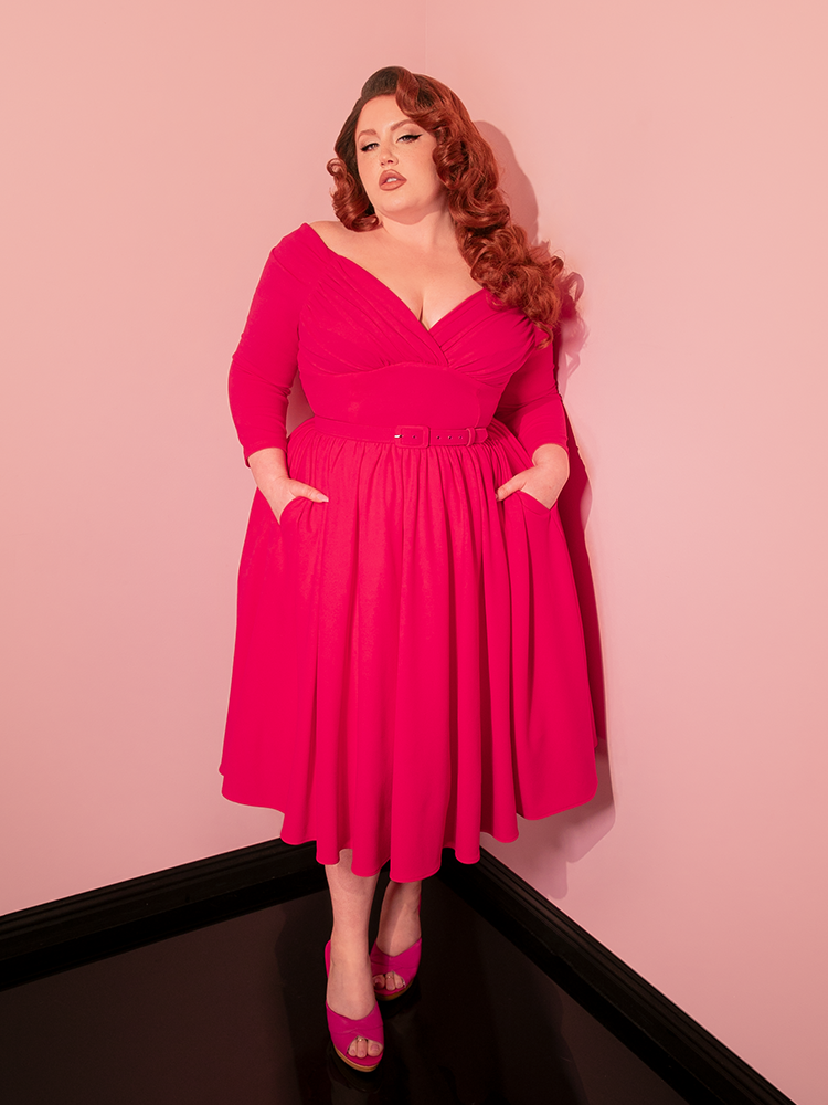 The Starlet Swing Dress in Fuchsia from Vixen Clothing is your ticket to vintage paradise. With its swing silhouette and bold color, it perfectly embodies the spirit of retro clothing, ensuring you'll turn heads at any retro-themed gathering.