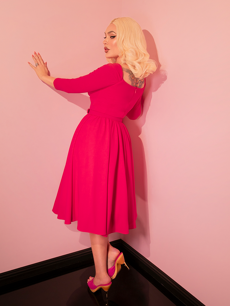 Dive into the charm of vintage dresses with the Starlet Swing Dress in Fuchsia. Designed by Vixen Clothing, this piece combines the vibrancy of retro fashion with the elegance of vintage styling, creating a look that's both nostalgic and chic.