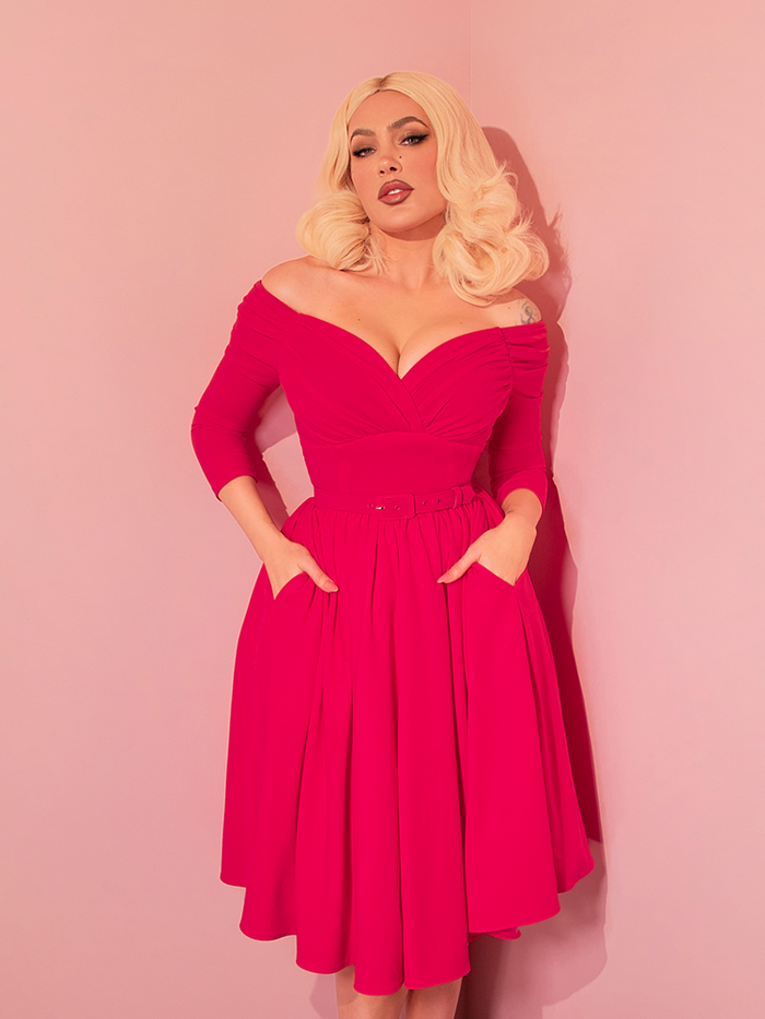 Imagine twirling in the Starlet Swing Dress in Fuchsia from Vixen Clothing, a piece that whispers tales of retro glamour. Its vibrant hue and classic silhouette make it a timeless addition to your vintage dress collection.