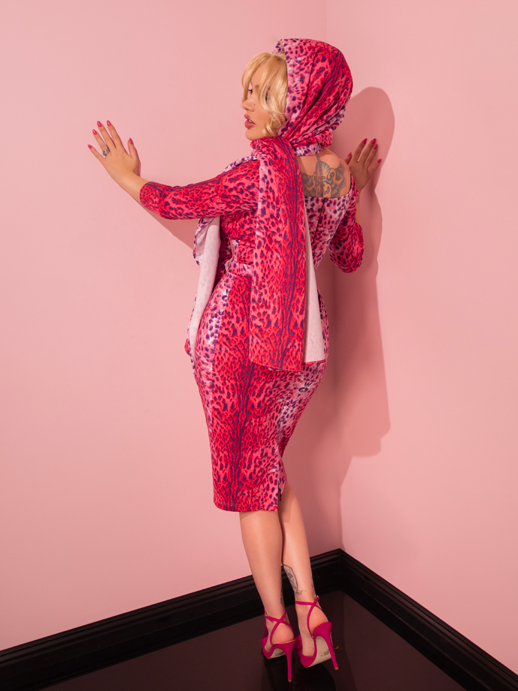 Step back in time with a stunning model as she brings to life the Pink Leopard Print Starlet Wiggle Dress and Scarf, a vintage treasure from the esteemed Vixen Clothing brand.