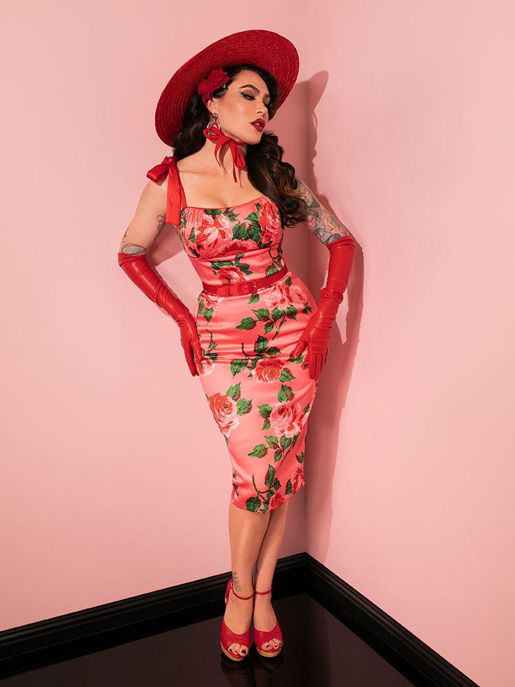 Vixen Clothing's 1950s Satin Wiggle Sundress and Scarf in Pink Vintage Roses are displayed with grace by the retro clothing model, embodying timeless style.