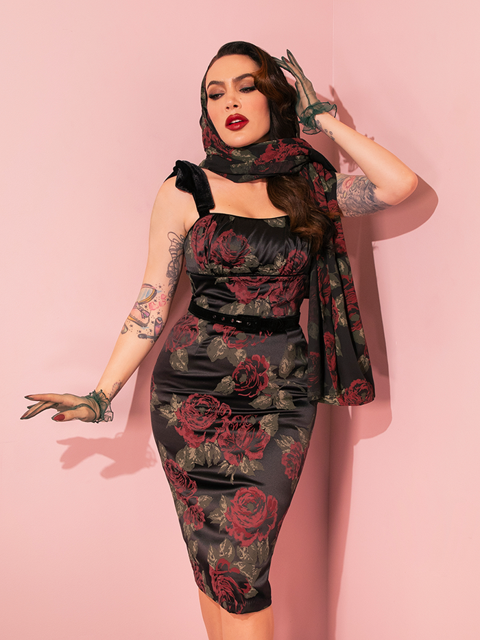  Stunning vintage models elegantly present the Black Vintage Roses 1950s Satin Wiggle Sundress and Scarf from Vixen Clothing, showcasing a range of poses.