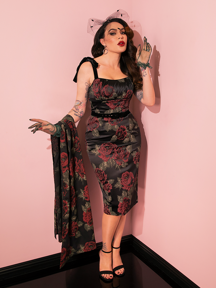 In a captivating display, lovely models highlight the 1950s Satin Wiggle Sundress and Scarf in Black Vintage Roses from Vixen Clothing, capturing the essence of retro style.