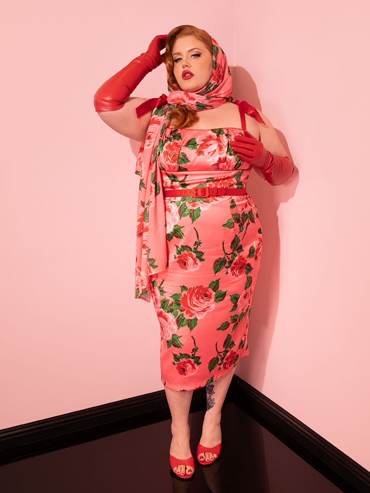 Playful and elegant, female vintage models strike poses in the 1950s Satin Wiggle Sundress and Scarf in Pink Vintage Roses from Vixen Clothing, epitomizing the brand's dedication to crafting unique retro dress pieces.