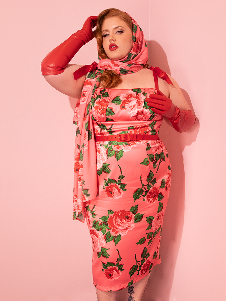 With a nod to vintage glamour, female vintage models showcase the 1950s Satin Wiggle Sundress and Scarf in Pink Vintage Roses by Vixen Clothing, a delightful addition to the brand's retro clothing repertoire.