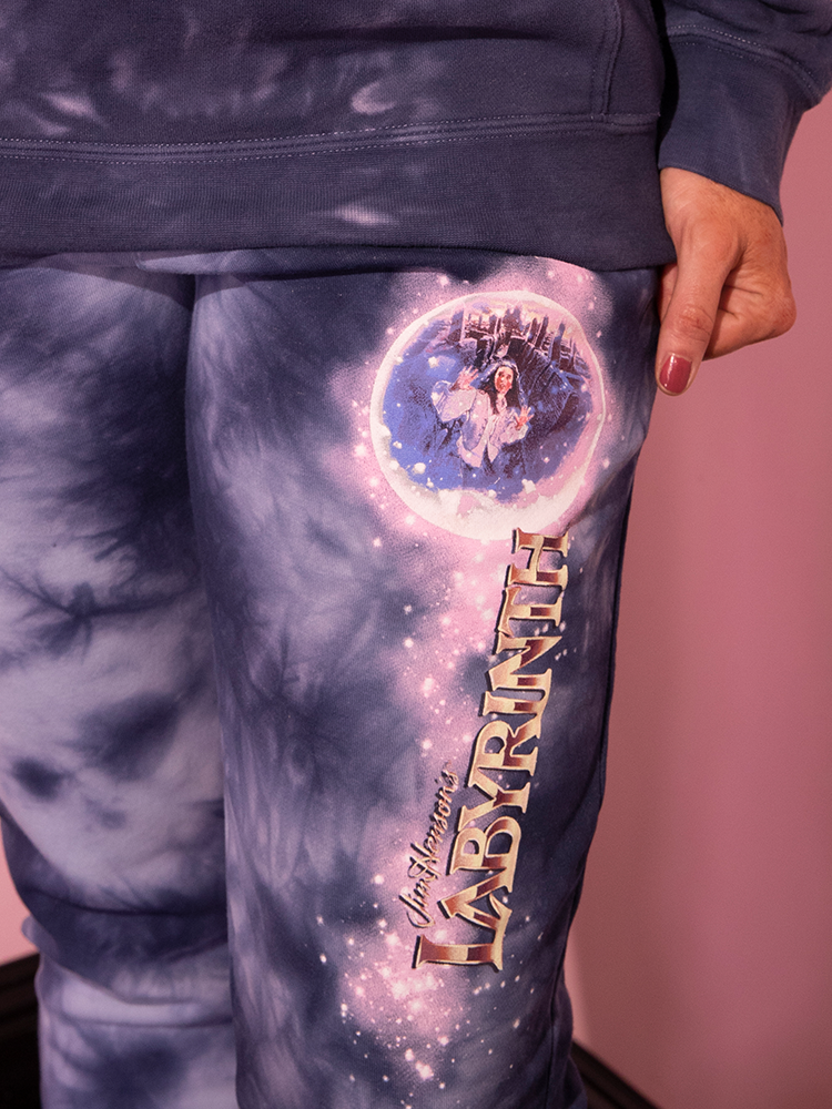 Prepare to be captivated by the vintage splendor of the LABYRINTH™ Goblin King Sweatpants in Midnight Blue Tie Dye, gracefully worn by a stunning mannequin, symbolizing the timeless charm curated by Vixen Clothing, the retro fashion connoisseur.
