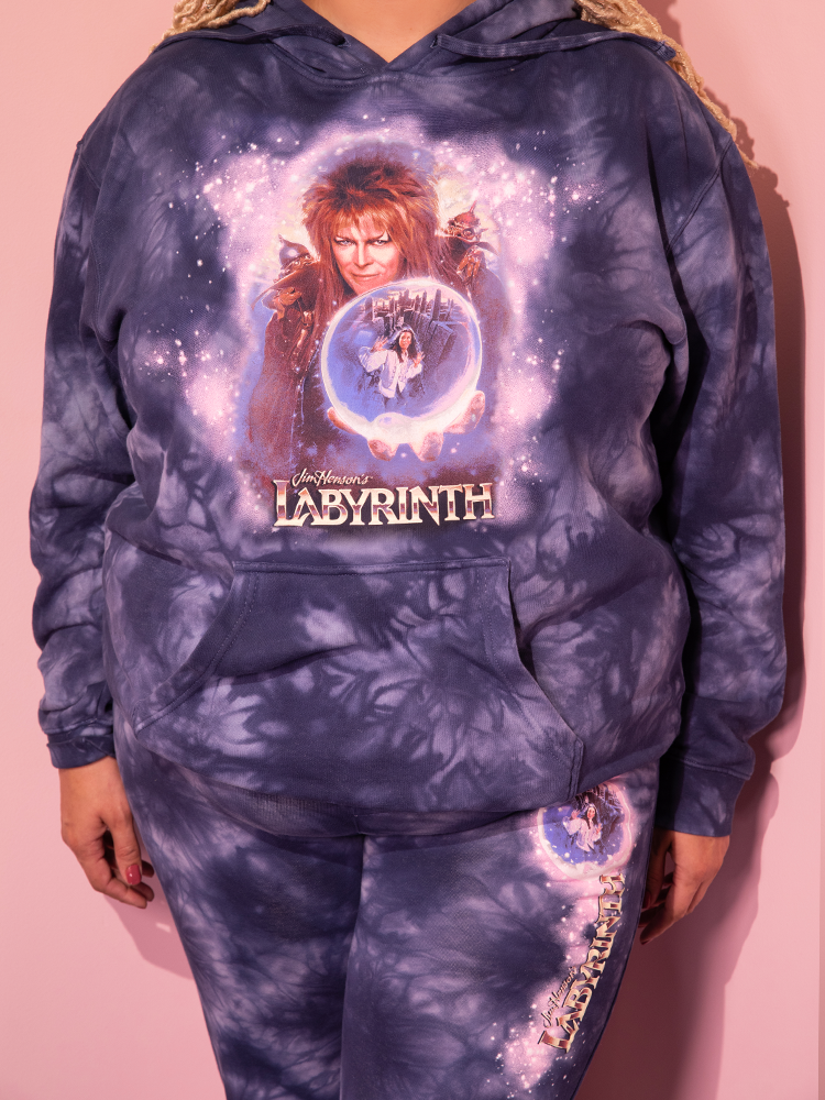 Behold the charm of the LABYRINTH™ Goblin King Hoodie in Midnight Blue Tie Dye, gracefully worn by our captivating model, courtesy of Vixen Clothing's retro offerings.