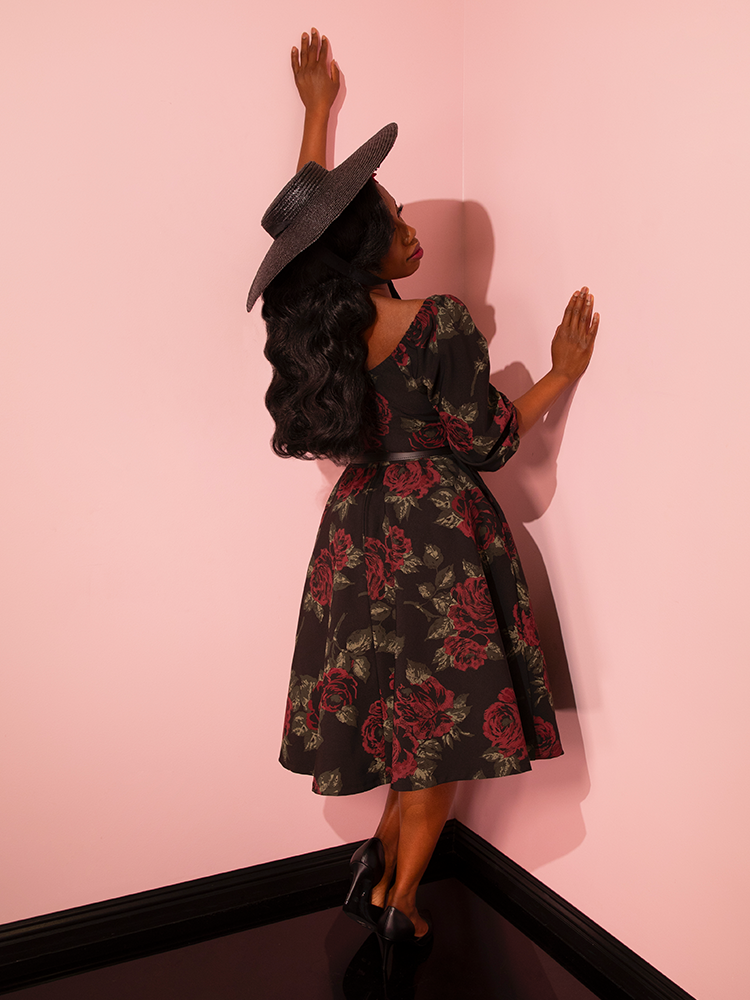 Infused with a sense of fun and flirty elegance, Vixen Clothing's Vacation Dress in Vintage Black Roses becomes the focal point as female vintage models strike poses, emphasizing the brand's mastery in designing unique retro dress pieces.