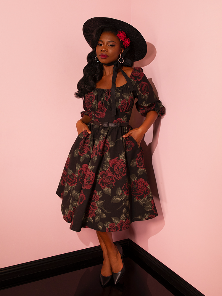 The Vacation Dress in Vintage Black Roses takes center stage as female vintage models showcase the perfect blend of fun and flirtation, embodying Vixen Clothing's expertise in crafting captivating retro dress styles.