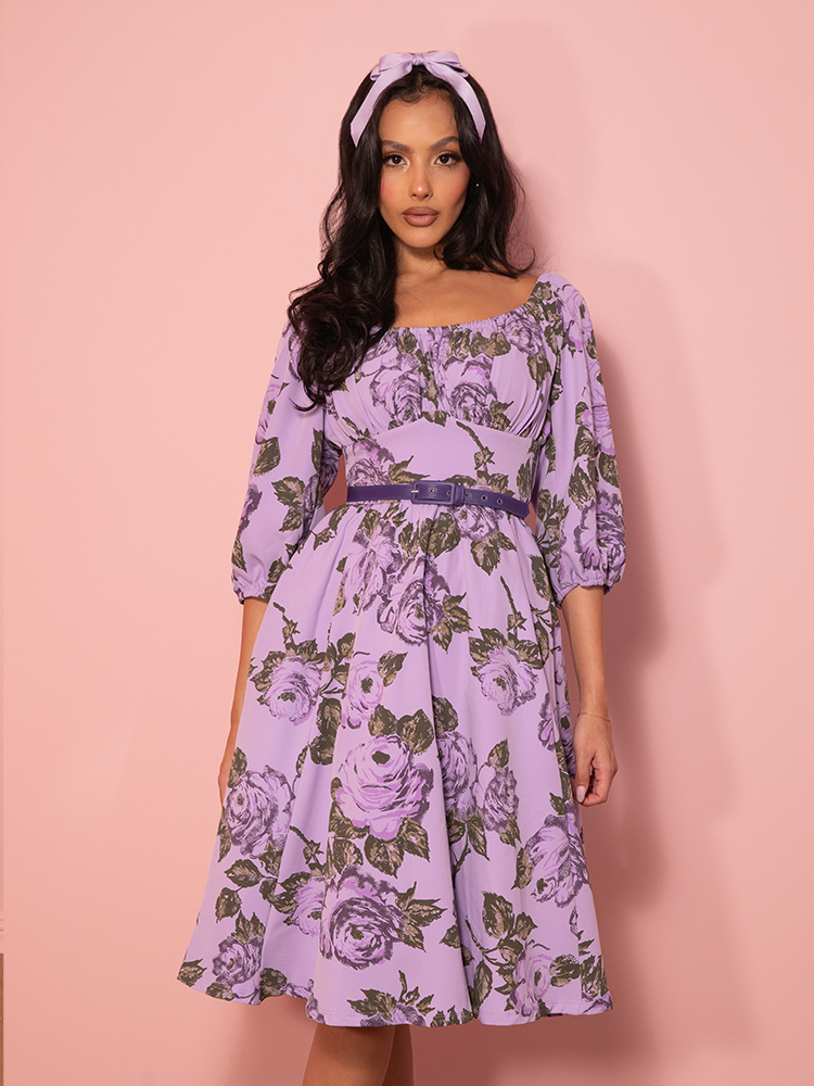 Full-body shot of the model mid-twirl, the flowing hem of the vintage dress catching motion and light.