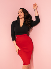 The Vixen Pencil Skirt in Red is a vintage-inspired staple, featuring a curve-hugging silhouette and bold color for timeless elegance.

