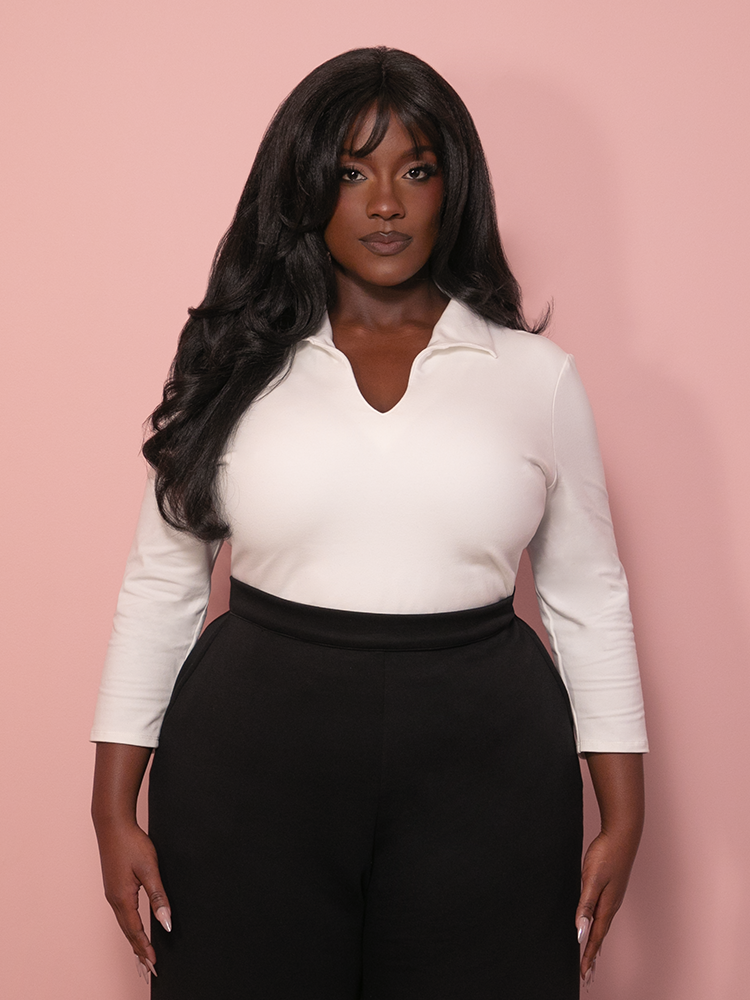 A form-fitting white retro-style top with a tailored "New Fit" design that emphasizes a sharp hourglass silhouette through darted construction.