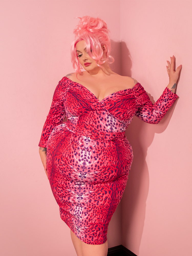 Marvel at the timeless elegance of a female model, radiating vintage vibes while donning the Pink Leopard Print Starlet Wiggle Dress and Scarf, meticulously designed by Vixen Clothing.