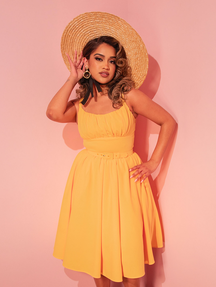 Elevate your fashion game with the Ingenue Dress in Sunshine Yellow, a retro style dress that blends nostalgic charm with contemporary chic.