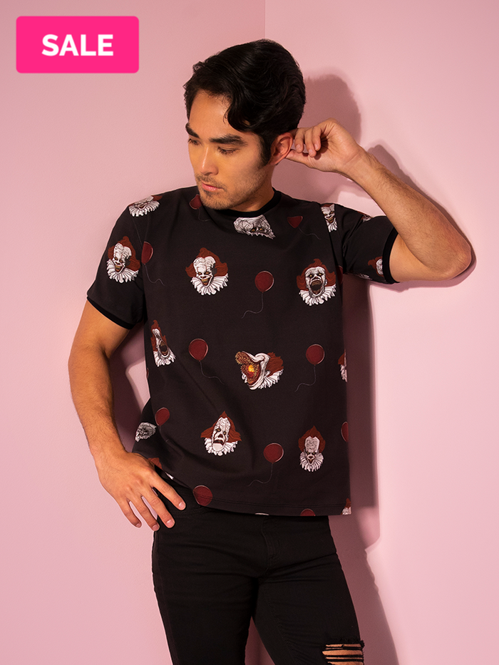A closeup of Ethan modeling the Pennywise ringer tee by Vixen Clothing.