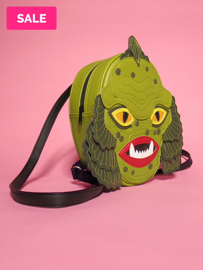 Retro style creature bag with leather stitching and black strap.