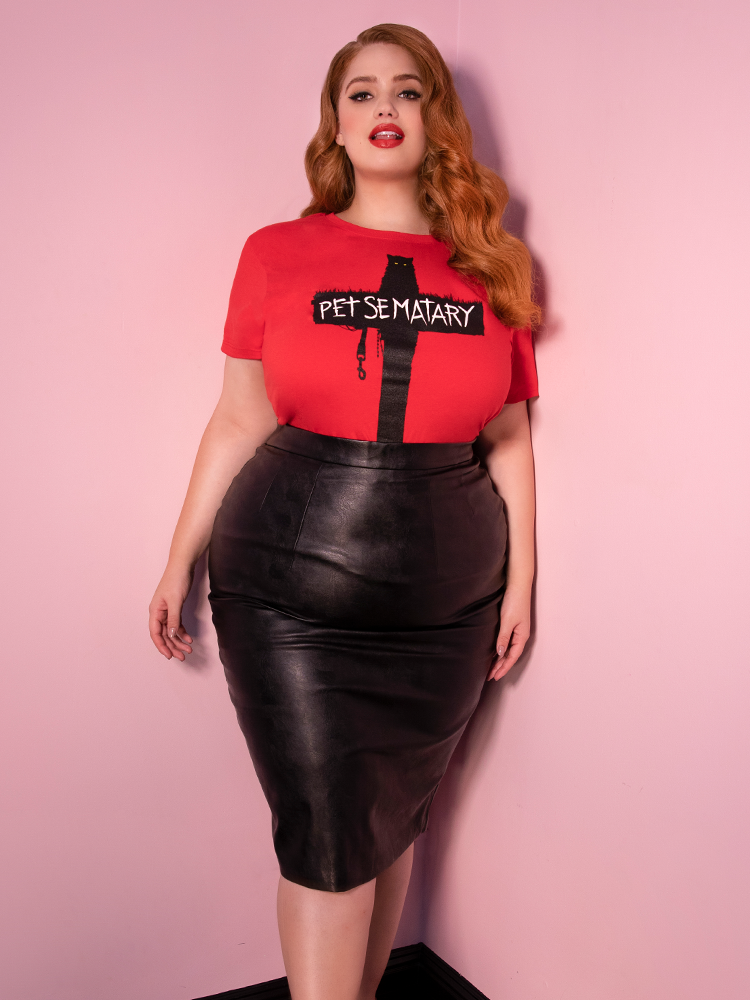 A closeup of Bree Kish wearing a red Pet Sematary top modeling the Vixen pencil skirt in vegan leather.