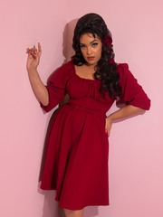 Ashleeta modeling a ruby red retro style dress from Vixen Clothing.