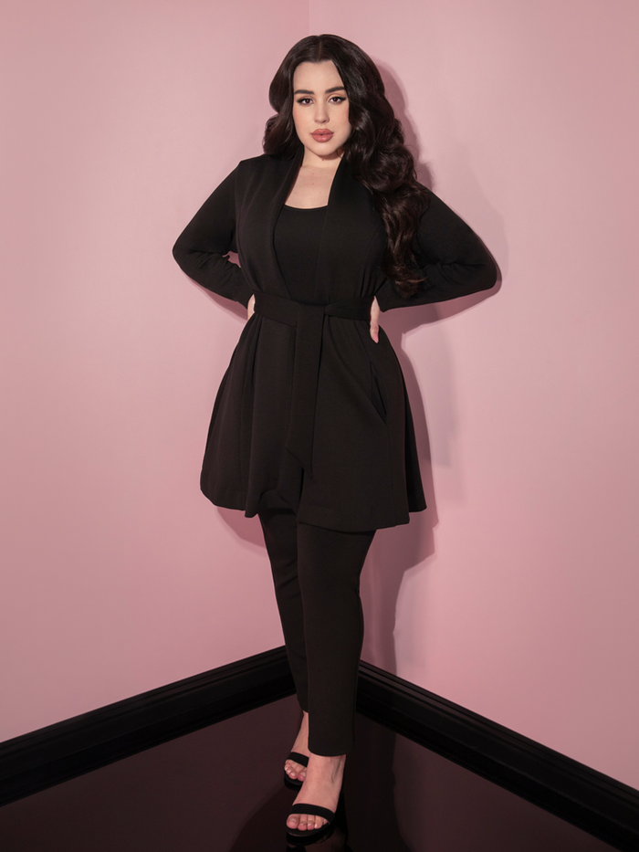 Full length shot of Rachel Sedory wearing the Cozy Cardigan Coat in Black paired with black cigarette pants, black top and black open-toed shoes.