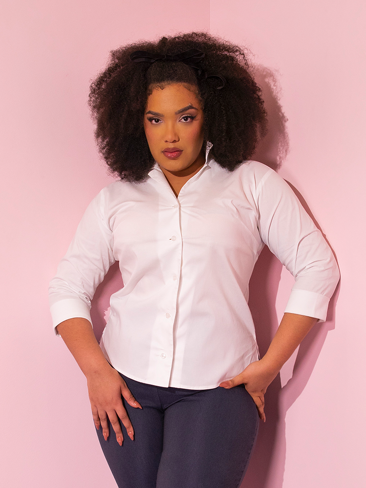 Model striking a serious pose in the 1950's Vintage Style Button Up Blouse in White. 
