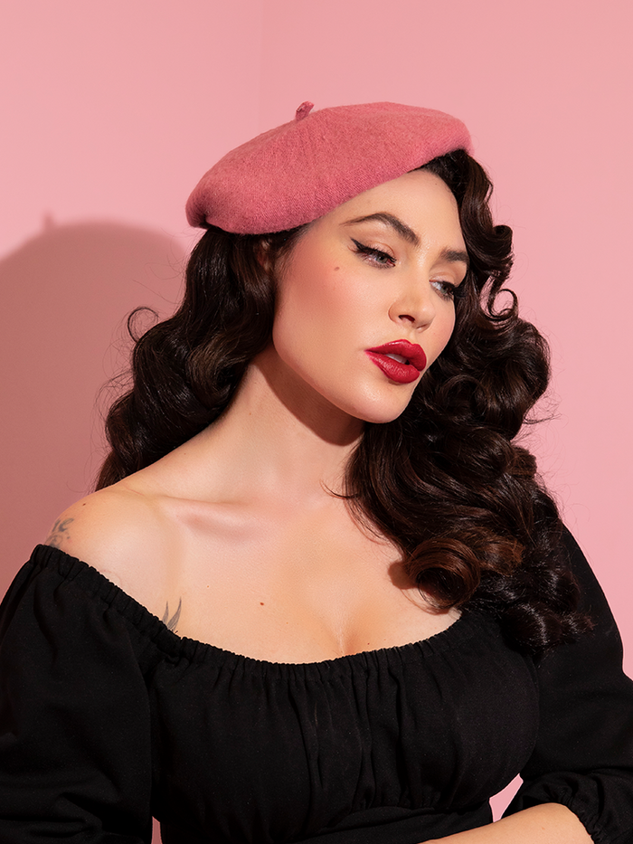 Portrait style shot of Micheline Pitt wearing the Vintage Style Beret in Rose Pink from Vixen Clothing.