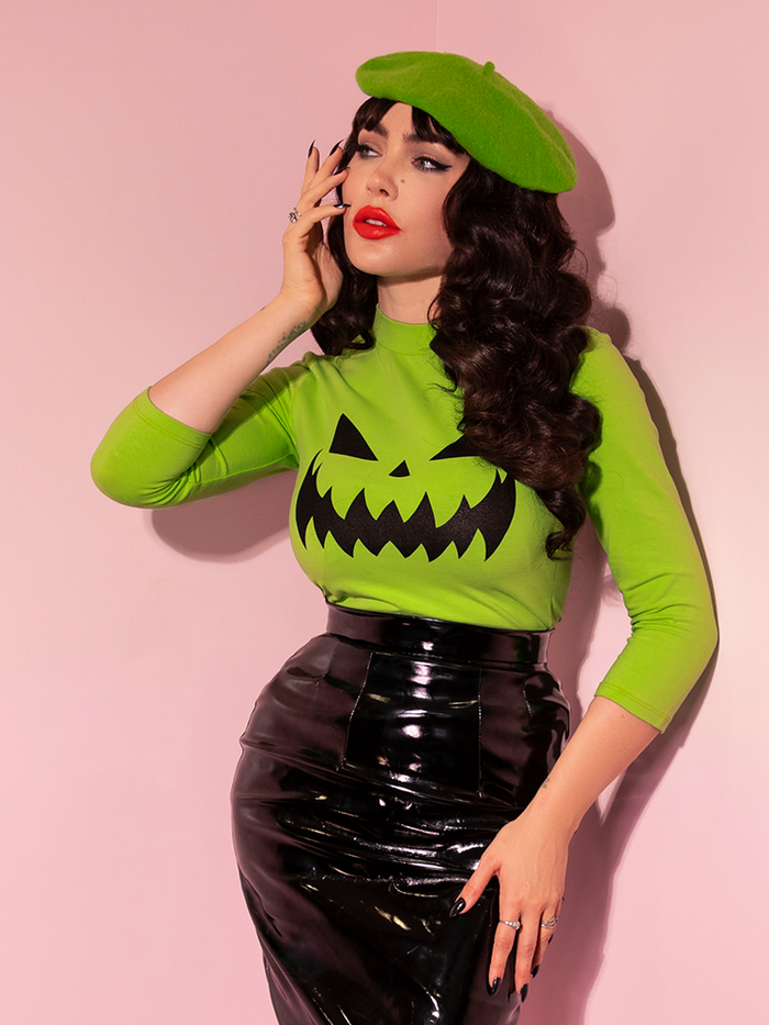 Micheline Pitt in the Pumpkin King 3/4 Sleeve Top in Slime Green from vintage clothing brand Vixen Clothing.