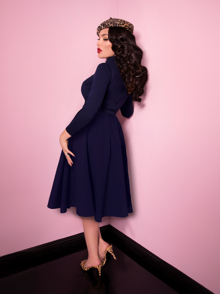 Back shot of Micheline Pitt wearing the Bad Girl Swing Dress in Navy from Vixen Clothing.