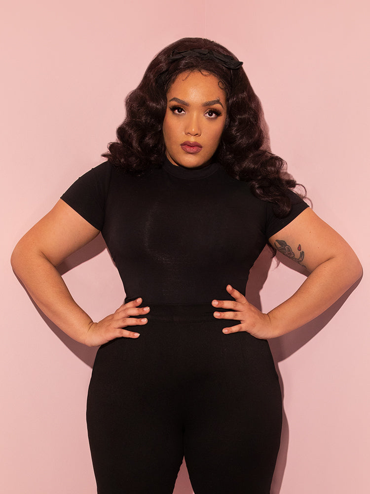In Vixen Clothing's Bad Girl Crop Top in Black, Ashleeta models a retro style with finesse.