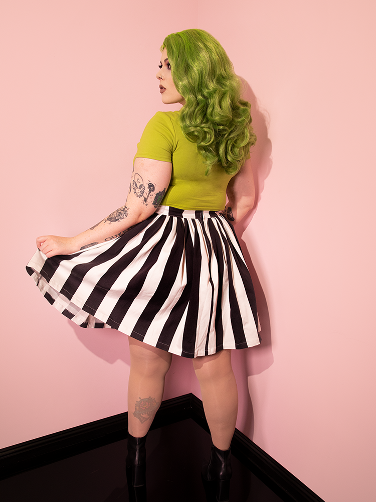 Back of the Ghost Skater Skirt in Black & White Stripes being worn by model with green top and matching hair color. 