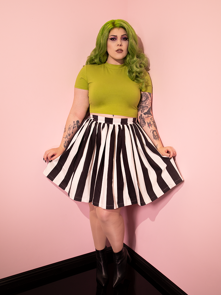 Model with green hair and matching retro top wearing the Ghost Skater Skirt in Black & White Stripes.