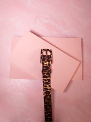 Add a sleek, vintage-inspired touch to your look with this 1" leopard sateen belt, perfect for cinching your waist with a hint of wild elegance. A bold accessory to complement any vintage style dress.