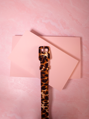 Add a bold, vintage-inspired edge to your look with this 1" leopard crepe belt, perfect for defining your waist with fierce style. A statement accessory to pair with a classic vintage dress for a touch of wild glamour.