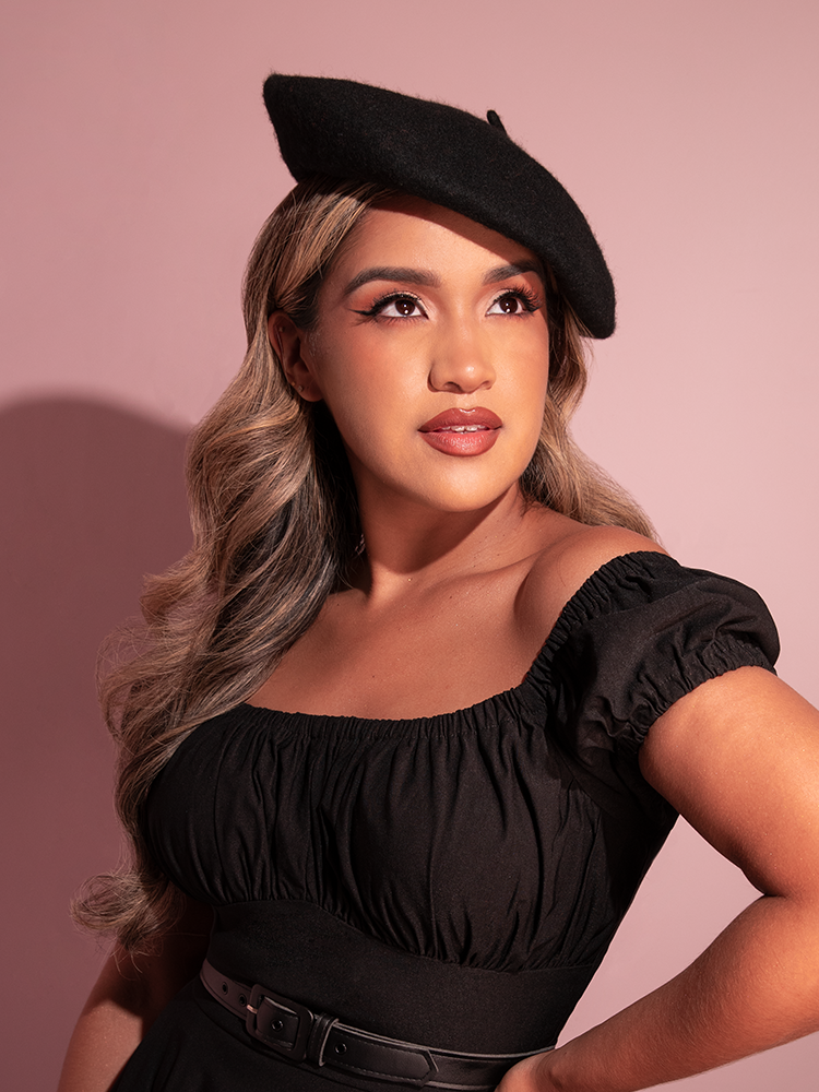 Female model looks upwards while wearing the Vintage Style Beret in Black.