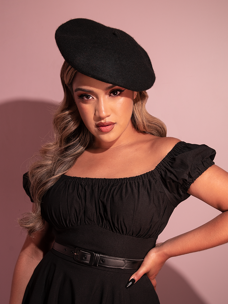 The Vintage Style Beret in Black being worn by female model from Vixen Clothing.