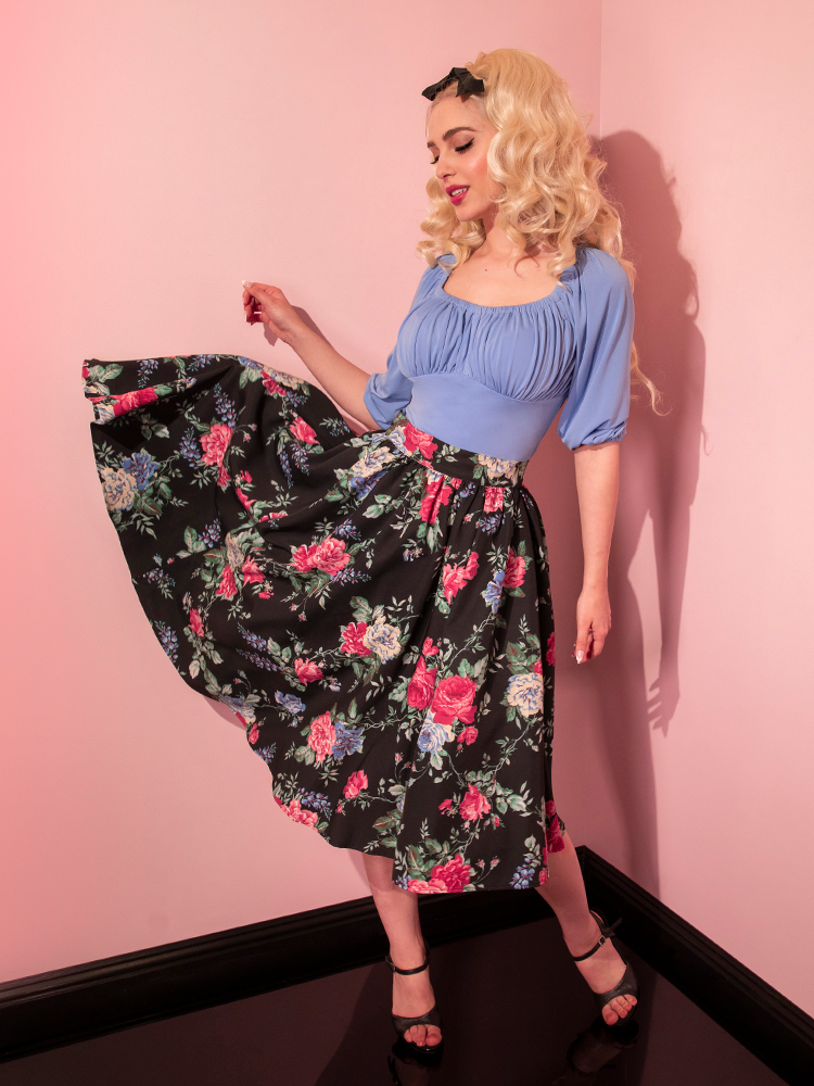 Model tosses out the side of the Vacation Swing Skirt in Black Vintage Rose Print to show off the gorgeously floral print. 