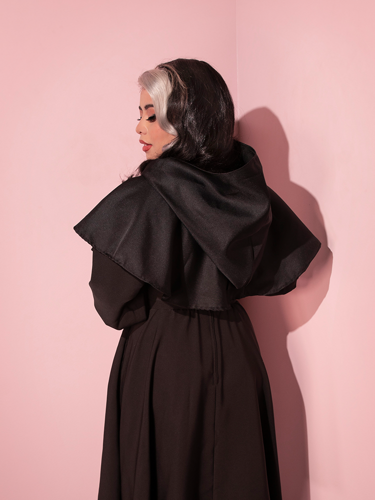 The back of the Hooded Witch Capelet in Black as worn by Margo.