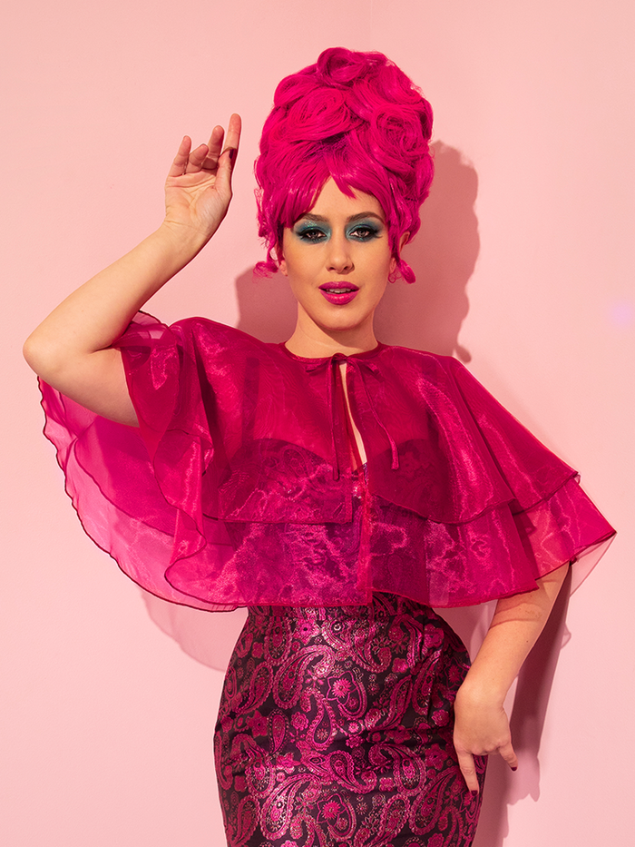 Ashley Thomson wearing the Vintage Capelet in Fuschia over a brilliantly colored vintage style dress.