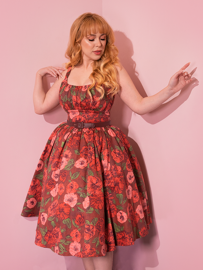 The playful charm of Vixen Clothing is brought to life as beautiful retro-inspired models pose playfully in the Chocolate Rose Print Ingenue Dress.