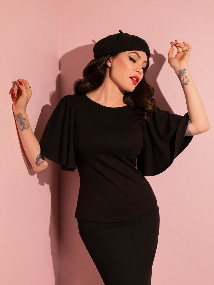 The Deadly Kiss Top in Black being worn by retro clothing model and brand owner Micheline Pitt. 