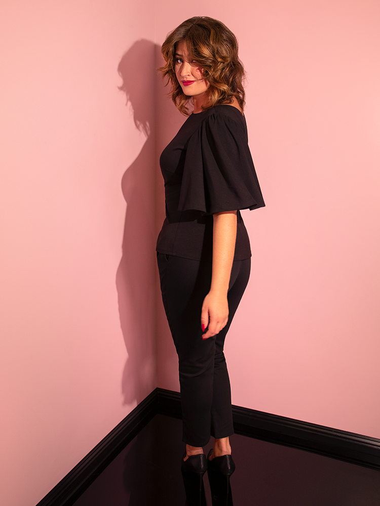 Side shot of Francesca wearing the Deadly Kiss Top in Black to show off the flowy sleeves.