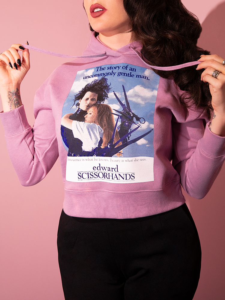 Close up of the movie poster emblazoned on the front of the EDWARD SCISSORHANDS Graphic Cropped Hoodie in Wisteria.