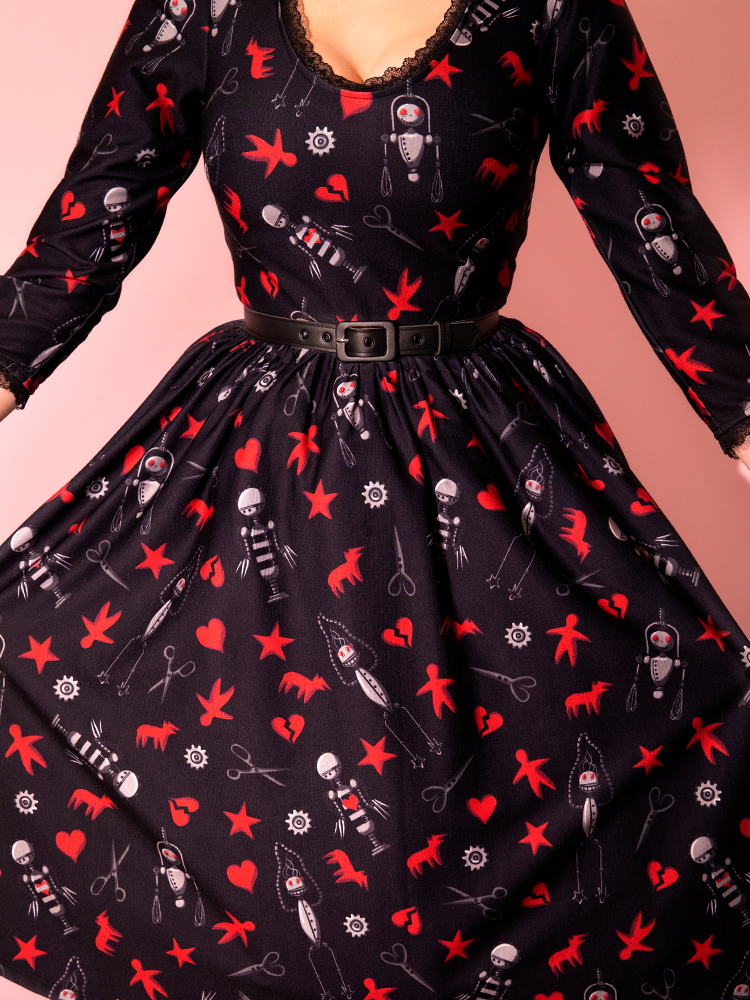 Close-up on the print of the EDWARD SCISSORHANDS Storytime Swing Dress in “I am not complete” Novelty Print from retro dress company Vixen Clothing.