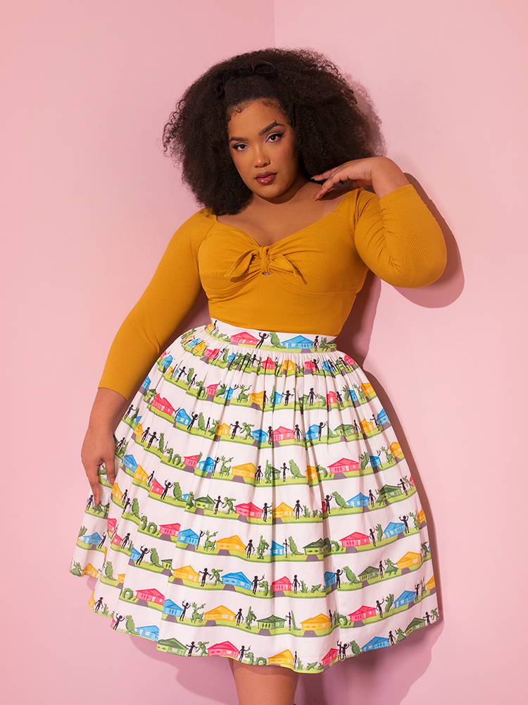 Ashleeta posing in the EDWARD SCISSORHANDS Swing Skirt in Suburban Topiary Novelty Print with a retro style top tucked into it.